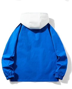 Detail of blue and white hooded windbreaker back view with elasticated cuffs and premium fabric