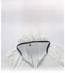 Detail view of the white sun protection jacket with a zipper closure and navy trim