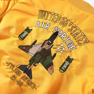 Yellow bomber jacket with detailed military aircraft embroidery and vintage style patches