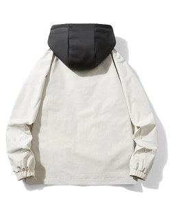 Detail of hooded windbreaker jacket with color-block design and elastic cuffs on back