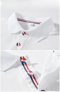 Detail of white polo shirt neckline with red, white and blue striped ribbon trim