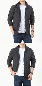 Detail of dark grey hooded jacket featuring vertical chest zip pocket and elastic cuffs