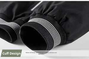 Close-up of black jacket ribbed cuff with white stripes and premium windproof fabric