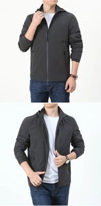 Detail view of men's grey windproof jacket with smooth zippers and functional pockets