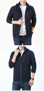 Detail of navy blue hooded windbreaker jacket with waterproof chest zipper and stretch cuffs