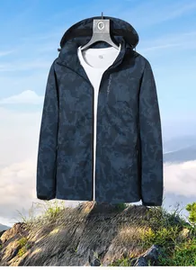 Close-up of camo outdoor jacket featuring waterproof zippers and honeycomb texture