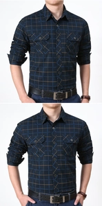Close-up detail of navy plaid cotton shirt with dual buttoned chest pockets and collar