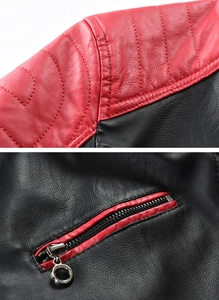 Close-up of red and black leather jacket with stitched panels and metal ring zipper pull