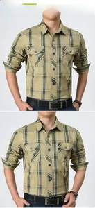 Detail of khaki plaid shirt featuring double workwear chest pockets and standard collar
