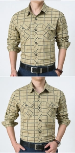 Detail of khaki plaid shirt with double chest pockets and rugged cotton fabric texture