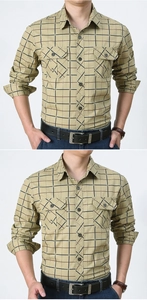 Detail of khaki plaid shirt featuring double chest pockets and rugged cotton fabric texture