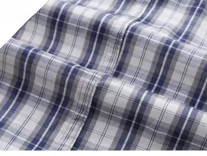 Detail of blue plaid fabric showing high-quality double-needle stitching and texture