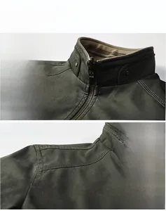 Detailed view of dark olive tactical jacket showing stand collar and reinforced shoulder seams