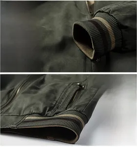 Detail of ribbed knit cuffs and hem with striped patterns on green bomber jacket