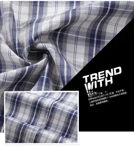 Detailed view of blue and white plaid fabric texture with precise stitching on summer shirt