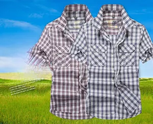 Detail of plaid short sleeve shirt featuring classic collar and double chest pockets