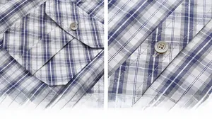 Detail of plaid shirt featuring a flap pocket and amber resin buttons on cotton fabric