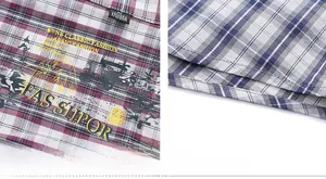 Detail view of plaid shirt collar labels and double-stitched hem on checked fabric