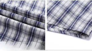 Detailed view of blue and white checkered cotton fabric with clean hemline stitching