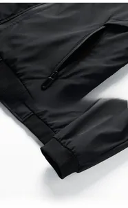 Detail of a black casual jacket showing hidden zipper pocket and ribbed elastic cuff