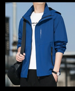 Detail of blue hooded windbreaker with X-SPORT logo and functional zipper pockets