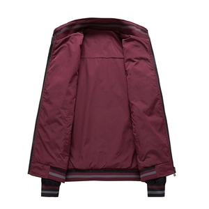 Detail view of burgundy bomber jacket showing the inner lining and striped knit ribbing edges