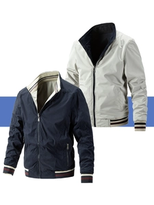 Detail of reversible bomber jacket showing striped ribbing on navy and beige cotton