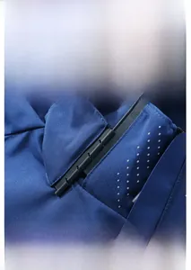 Detailed close-up of the windproof collar socket on this navy blue outdoor jacket