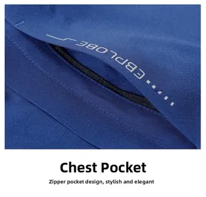 Detail of the navy blue windbreaker featuring a zippered chest pocket and premium fabric