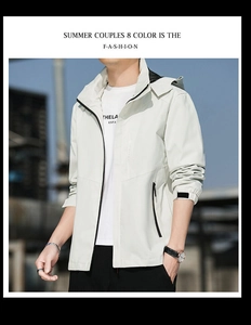 Close-up of windproof hooded outdoor jacket in light grey with adjustable velcro cuffs