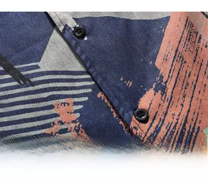 Close-up of abstract print shirt showing twill fabric texture and matte black buttons
