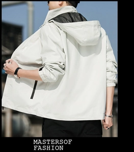 Detail of light beige hooded windbreaker featuring mesh lining and side zipper detail