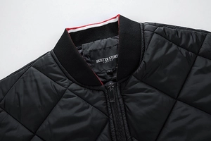 Detail of diamond quilted jacket with ribbed collar and signature striped trim