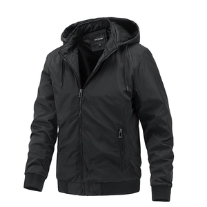 Detail view of black hooded windbreaker with zip pockets and ribbed elastic cuffs