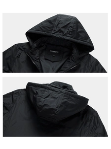 Detailed view of the jacket's detachable hood and premium zipper stitching on the neckline