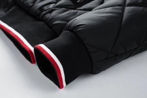 Detail of ribbed knit cuffs with red and white stripes on quilted winter jacket