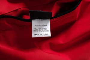 Detail view of garment care label showing 100% cotton shell and polyester lining fabric