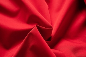 Close-up of premium red textile fabric texture showing high-quality weave and material
