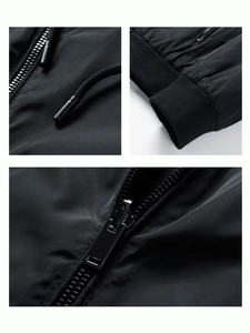 Detail of black jacket showing metal tip drawstring, ribbed cuffs and smooth resin zippers