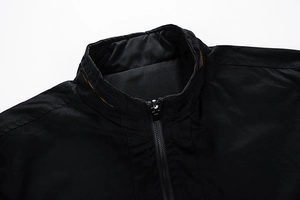 Detailed view of black stand collar jacket featuring precise stitching and high-quality zipper