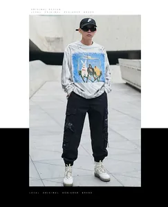 Detailed view of multi-pocket street style techwear cargo pants with elastic cuffs