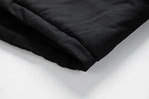 Detailed macro view of black washed jacket cuff showing neat stitching and durable fabric