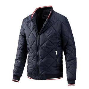 Men's navy blue quilted bomber jacket with diamond stitching and red-white striped ribbing