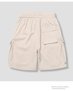 Detailed back view of beige retro cargo shorts with large flap pockets and woven texture
