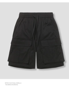 Detailed view of elastic waistband and functional drawstrings on black cargo shorts