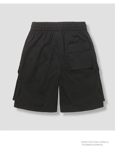 Detailed view of cargo shorts back pocket with functional flap and elastic waistband