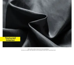 Macro view showing the smooth dark grey inner fabric lining and twill texture of the jacket