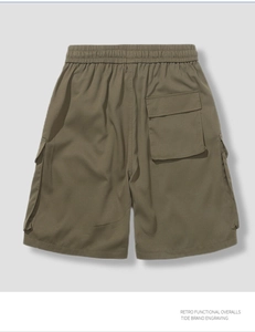 Detail of army green cargo shorts featuring elastic waistband and functional back pocket