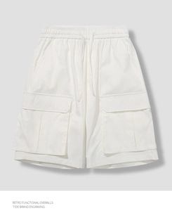 Detail of white retro functional overalls featuring elastic drawstring waist and cargo pockets