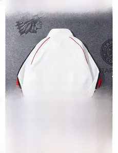 Detail view of white standing collar sports jacket with red and black side stripes